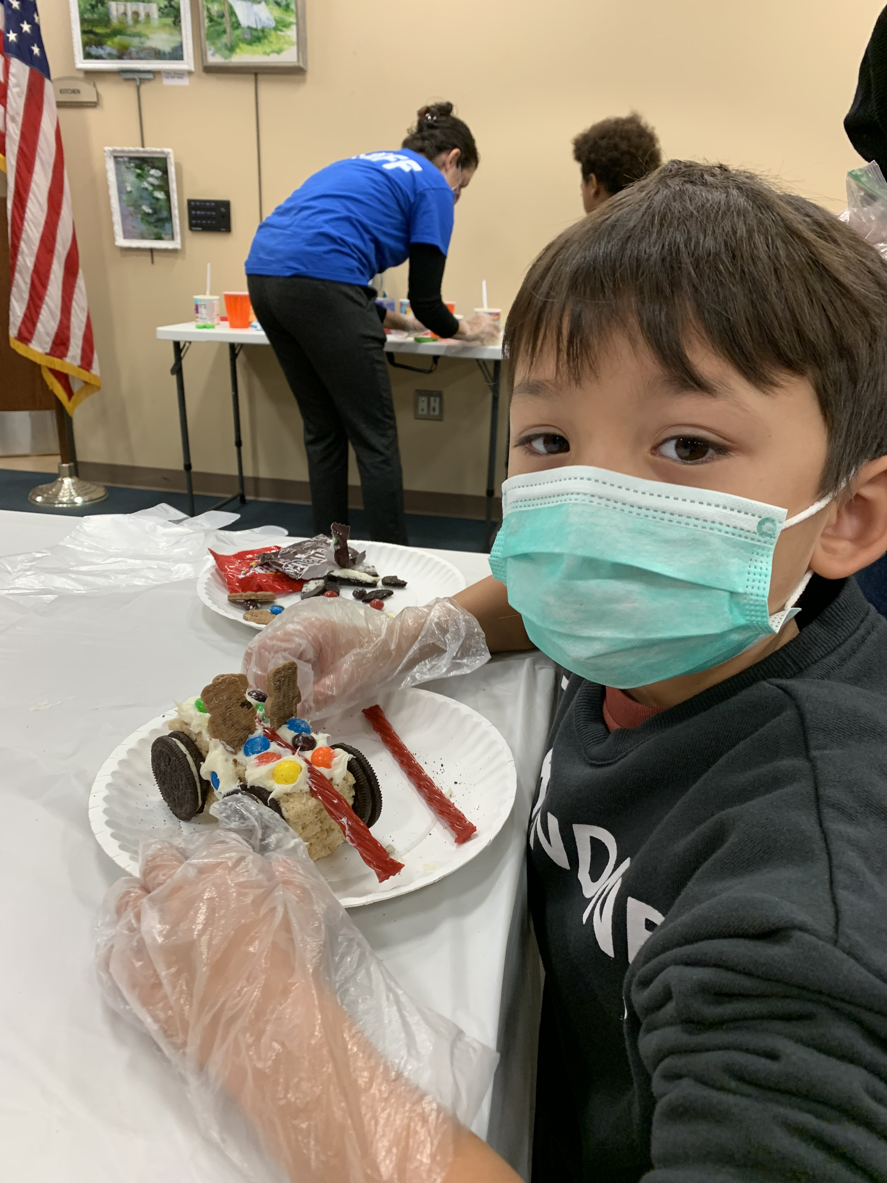 Young boy decorating his dessert at the SmithCon event
