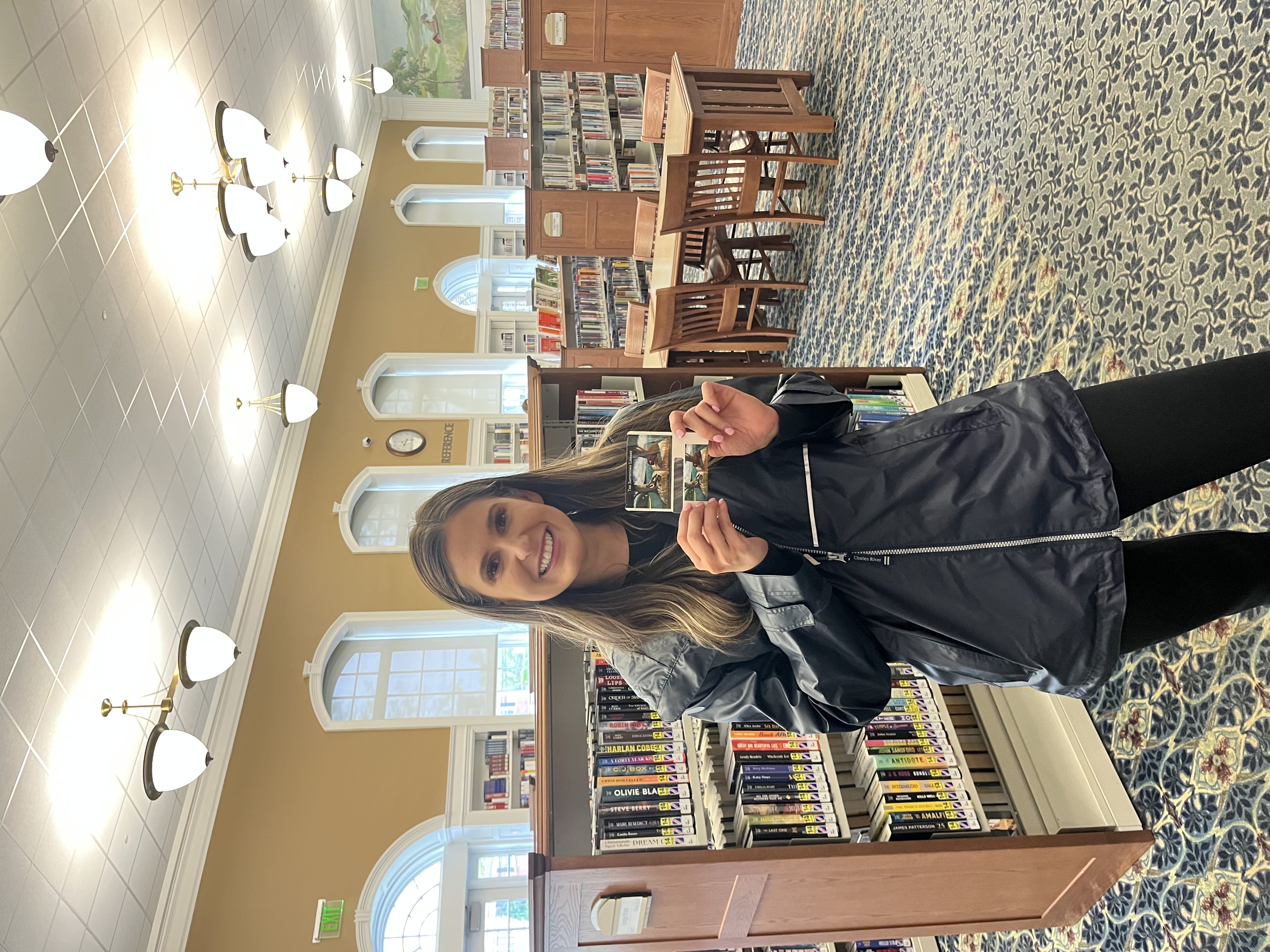 woman holding a library card