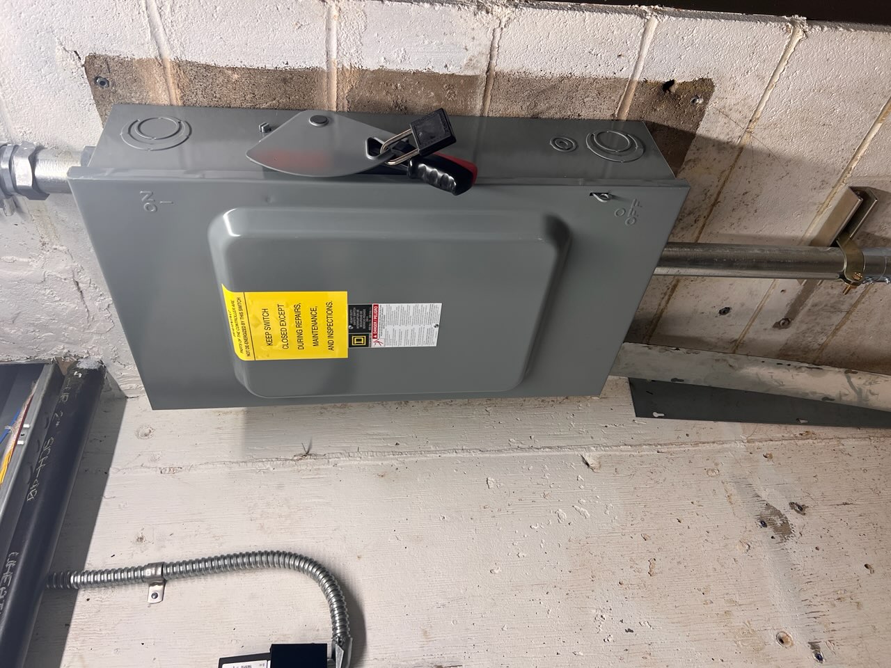 gray metal box attached to wall