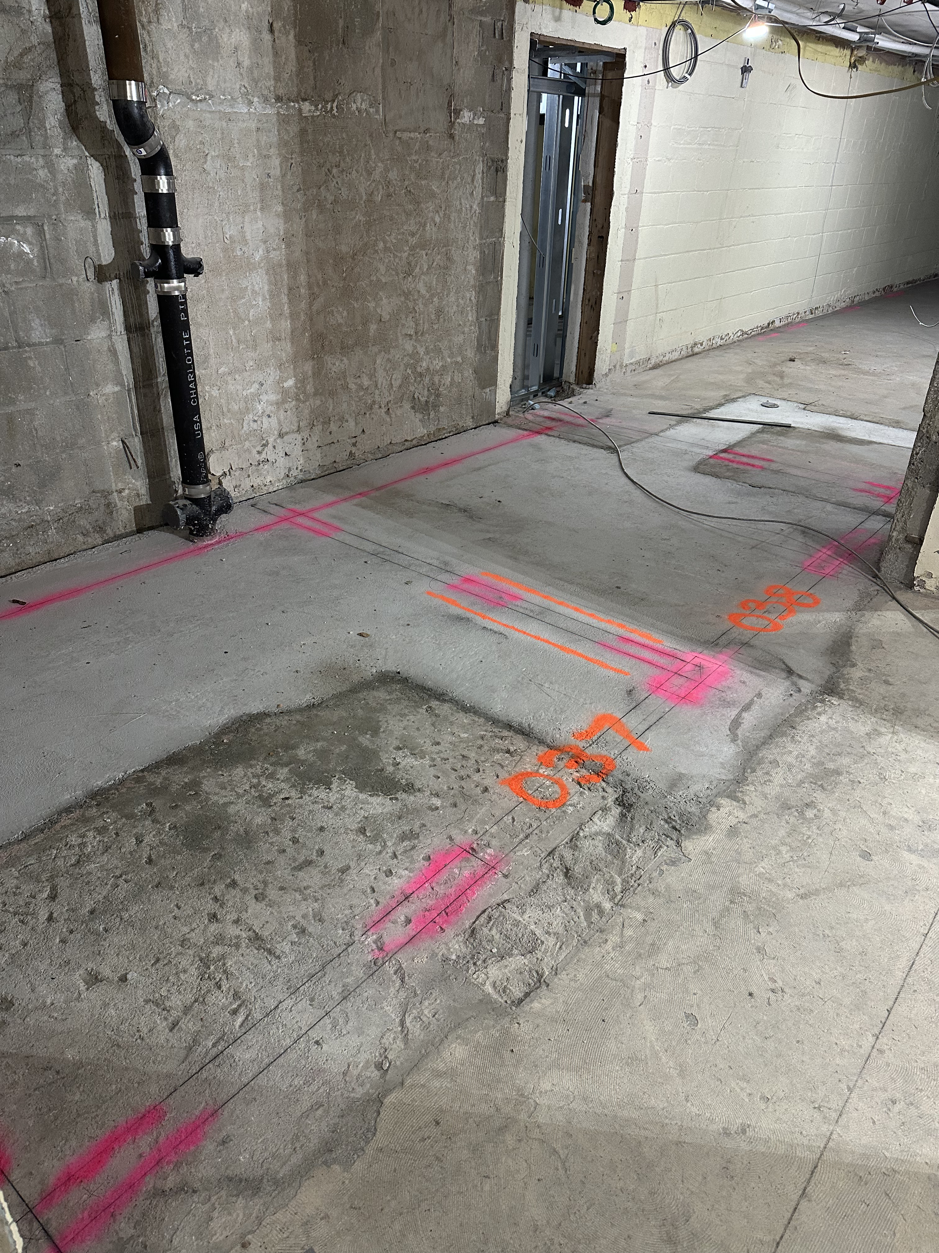concrte floor with pink and orange markings