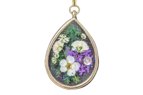 Pendant with dried flowers inside.
