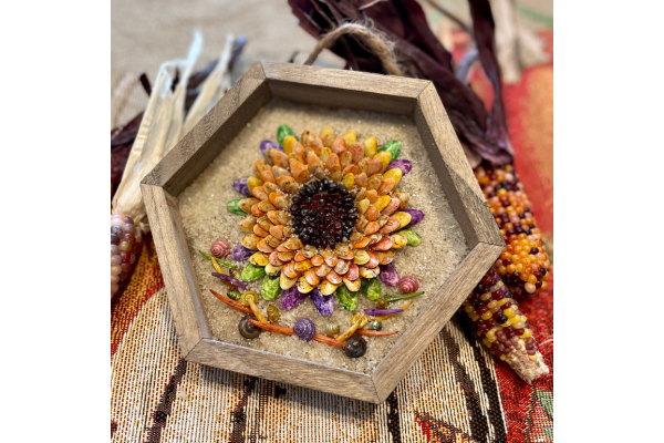 Framed sunflower made out of seashells.