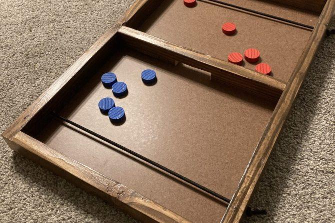 A wooden version of the board game pucket.