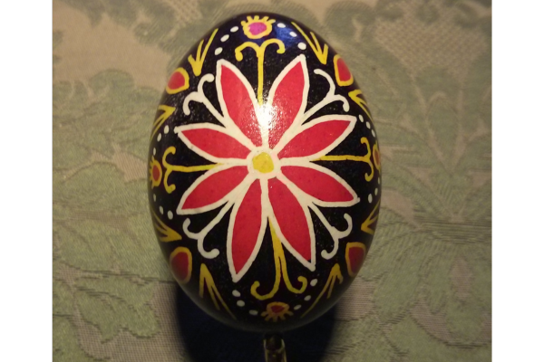 Egg decorated with intricate design. red, black yellow 