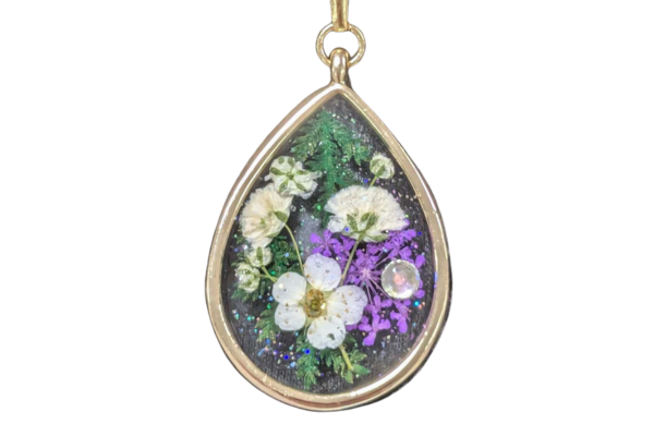 Pendant with dried flowers inside.