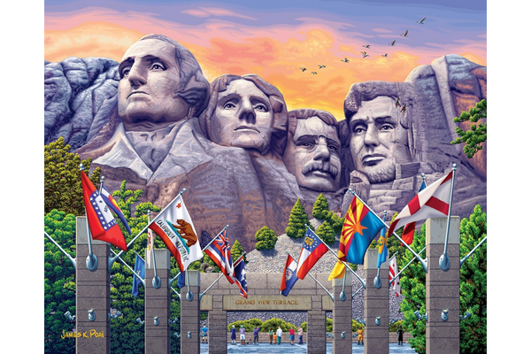 Mount Rushmore with flags in front.