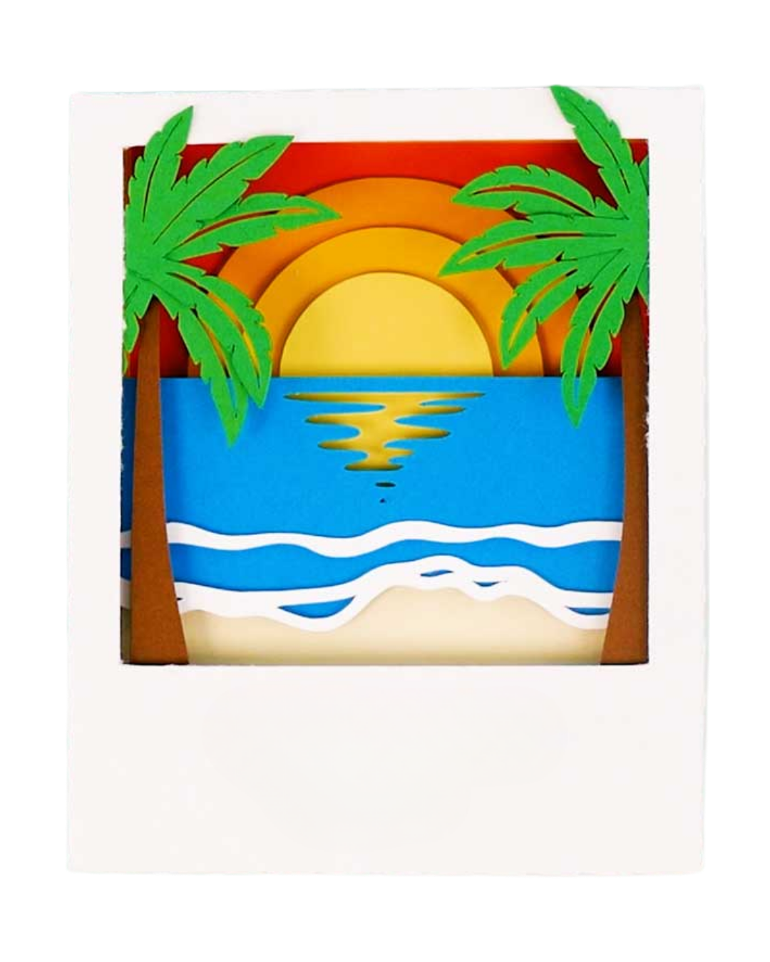 Image of a shadow box in a polaroid frame displaying a sunset surrounded by palm trees.