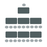 Individual tables with chairs along one side facing chair and table at the front of the room